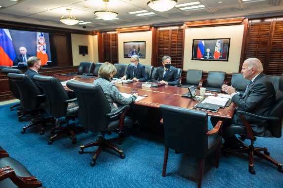 President Joe Biden speaks as he meets virtually via a secure video conference with Russian President Vladimir Putin