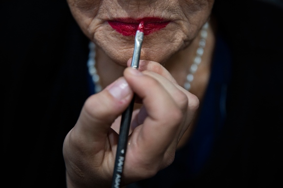 Holocaust survivor Rivka Papo, 87, gets makeup applied during a special beauty pageant