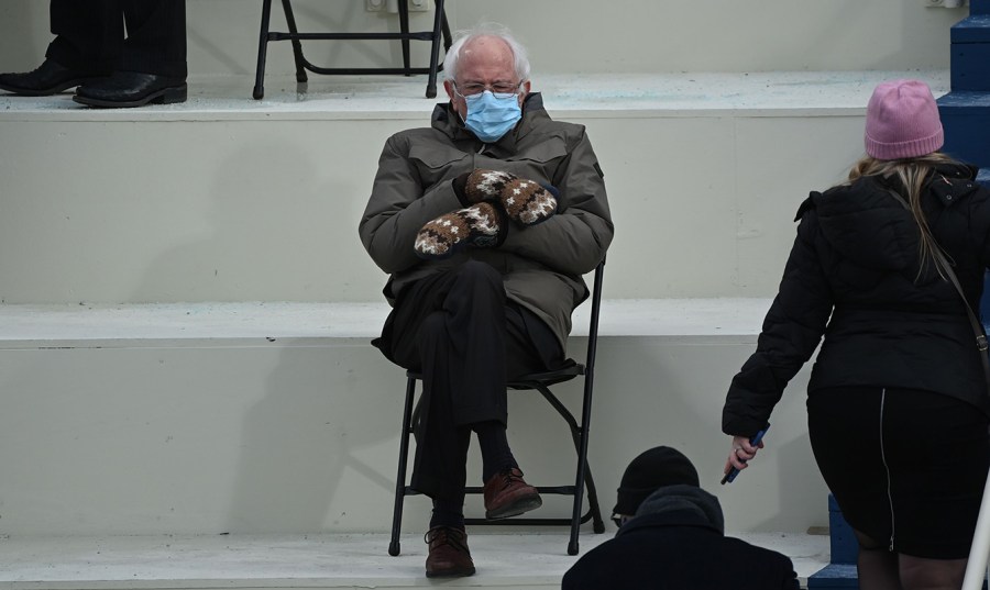 Bernie Sanders sits alone at inauguration wearing a coat, a mask and a pair of mittens.