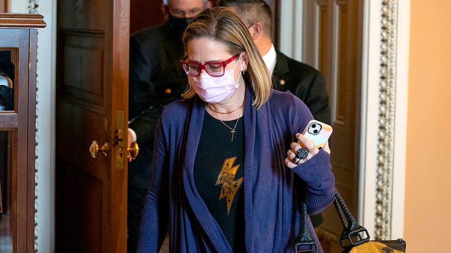 Sen. Kyrsten Sinema (D-Ariz.) leaves a Senate Democratic luncheon on Friday, December 17, 2021 to discuss the way forward on the legislative agenda.