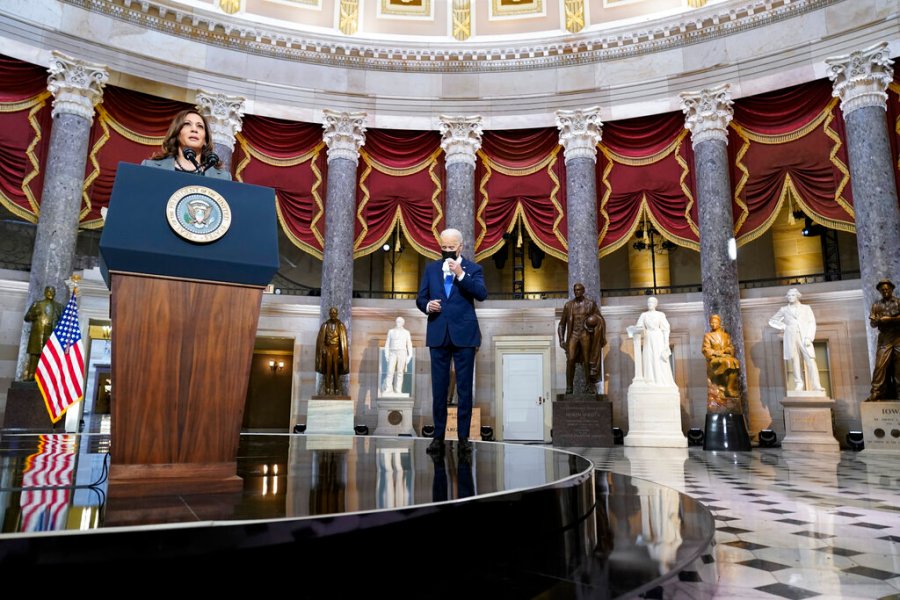 President Joe Biden reaches to wipe his eyes as Vice President Kamala Harris speaks from Statuary Hall at the U.S. Capitol to mark the one year anniversary of the Jan. 6 riot at the Capitol by supporters loyal to then-President Donald Trump, Thursday, Jan