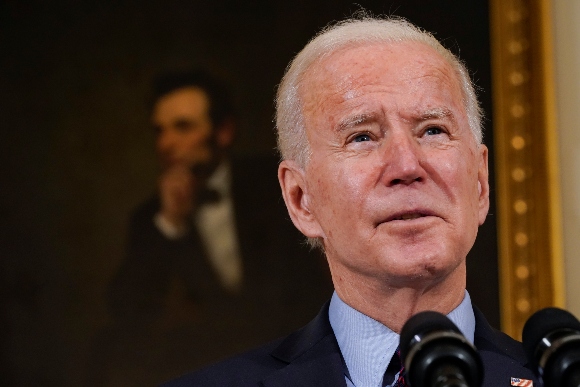 With a portrait of former President Abraham Lincoln behind him, President Joe Biden speaks about the economy