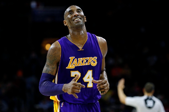 Los Angeles Lakers' Kobe Bryant smiles as he jogs to the bench