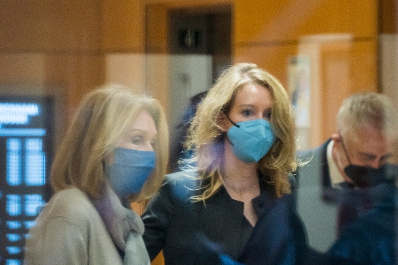 Elizabeth Holmes, center, enters federal court in San Jose, Calif.