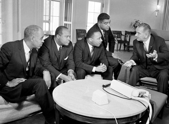 U.S. President Lyndon B. Johnson, right, talks with civil rights leaders including Dr. Martin Luther King Jr. in his White House office in Washington, D.C., Jan. 18, 1964.