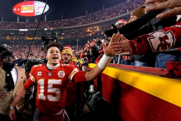 Kansas City Chiefs quarterback Patrick Mahomes (15) celebrates with fans after an NFL divisional round football game against the Buffalo Bills