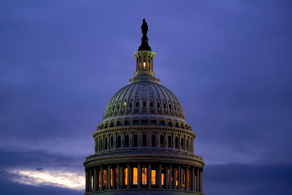 The light in the cupola of the Capitol Dome is illuminated, indicating that work continues in Congress