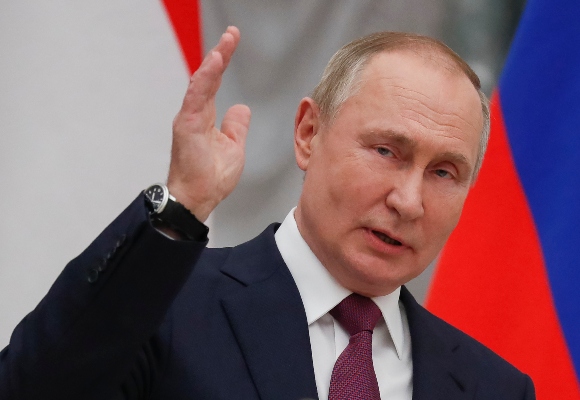 Russian President Vladimir Putin gestures while speaking