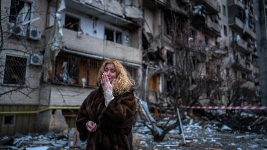 Natali Sevriukova reacts next to her house following a rocket attack the city of Kyiv, Ukraine