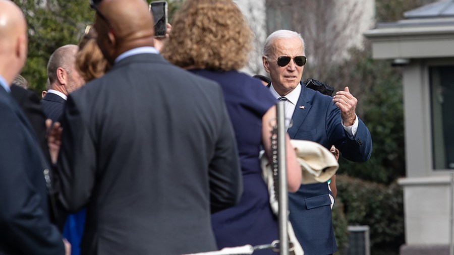 President Joe Biden talks to guests as he departs the White House in Washington, D.C. for Rehoboth, Delaware on Friday, March 18, 2022.