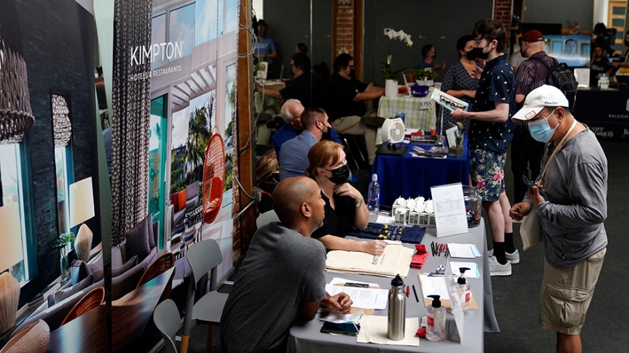 Hiring representatives speak with job seekers