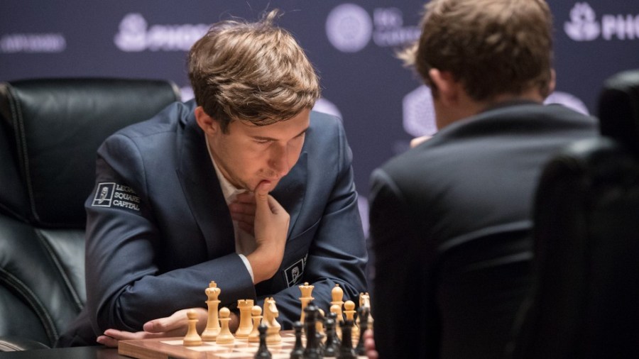 Sergey Karjakin, left, of Russia, concentrates on the board