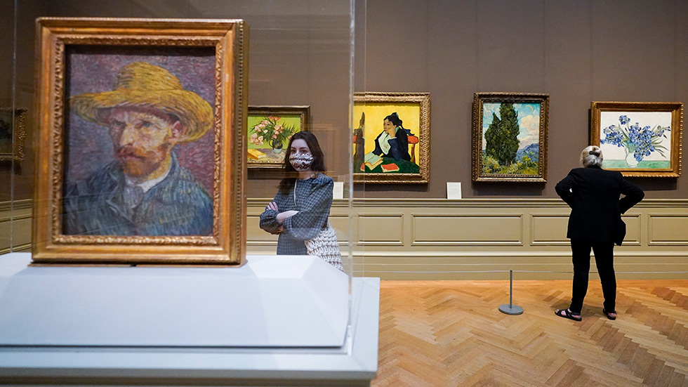 A visitor looks at a Van Gogh painting