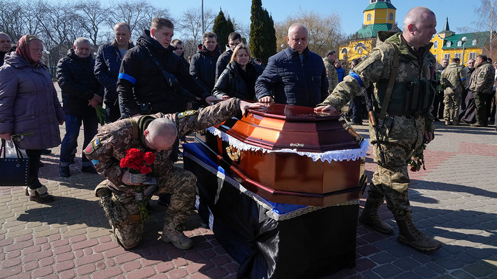 Ukrainian soldiers in a cemetery