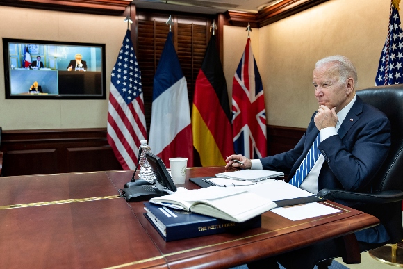 In this image provided by the White House, President Joe Biden listens during a secure video call 