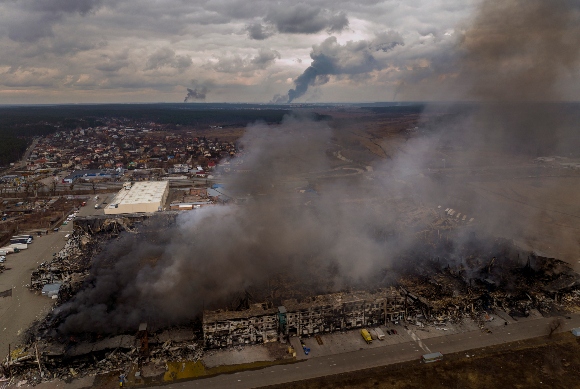 A factory and a store are burning after been bombarded in Irpin, in the outskirts of Kyiv