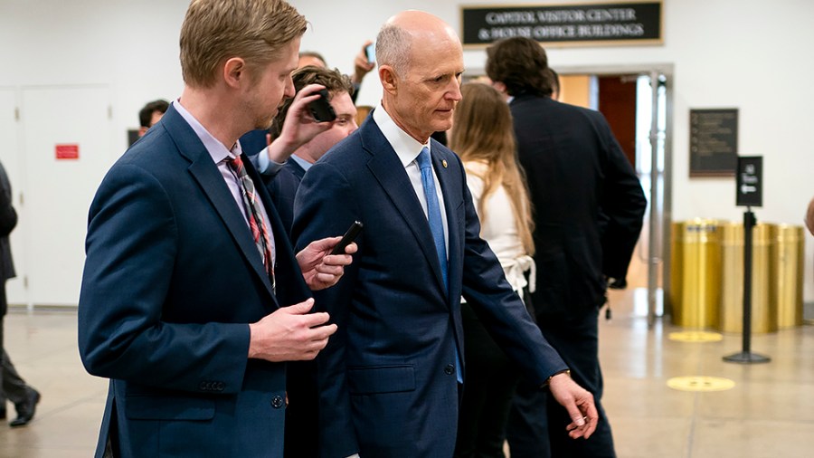 Sen. Rick Scott (R-Fla.) speaks to a reporter as he arrives to the Capitol on Wednesday, March 30, 2022.