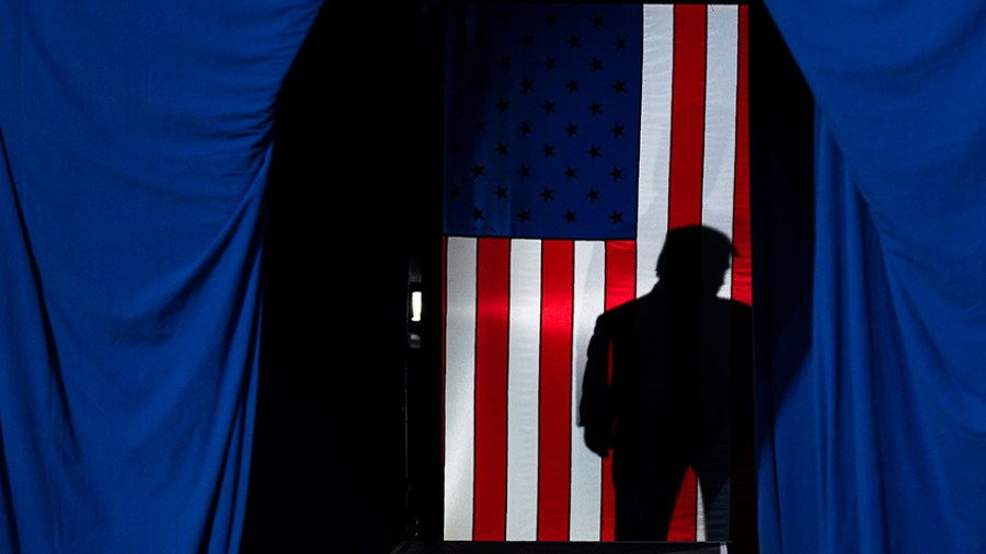 Shadow of Trump behind a curtain