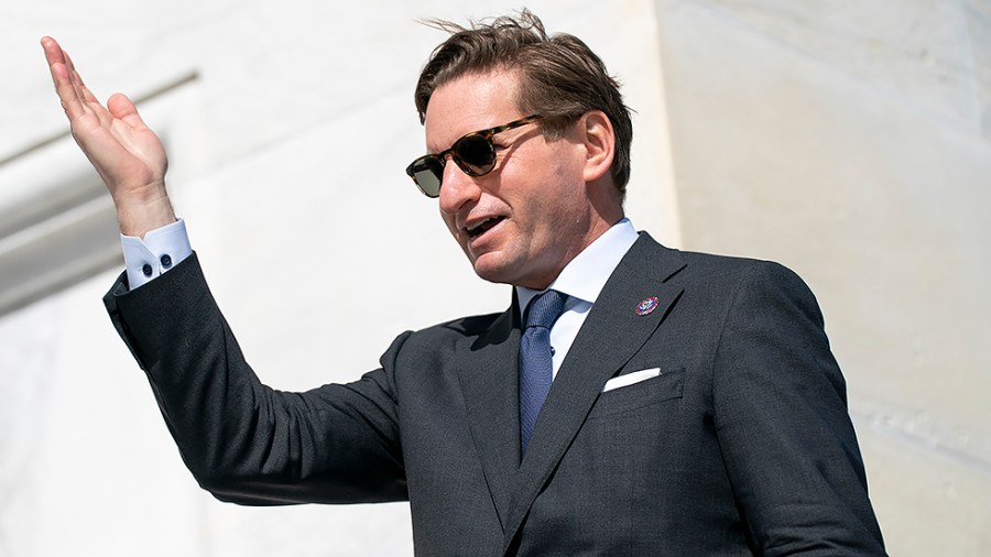 Rep. Dean Phillips (D-Minn.) jokingly works on his pageant wave as he leaves the Capitol following the final vote of the week on Thursday, March 3, 2022.