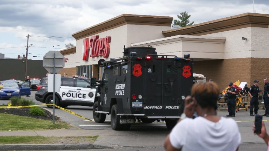 A crowd gathers as police investigate after a shooting at a supermarket on Saturday, May 14, 2022, in Buffalo, N.Y.