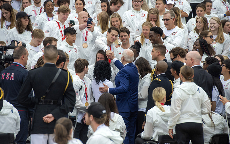 President Biden, center, shakes hands with members of Team USA