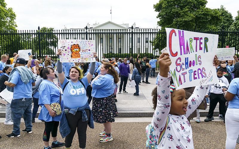 Students, parents and educators hold a rally for charter schools, with one child holding a sign saying "Charter Schools Matter"