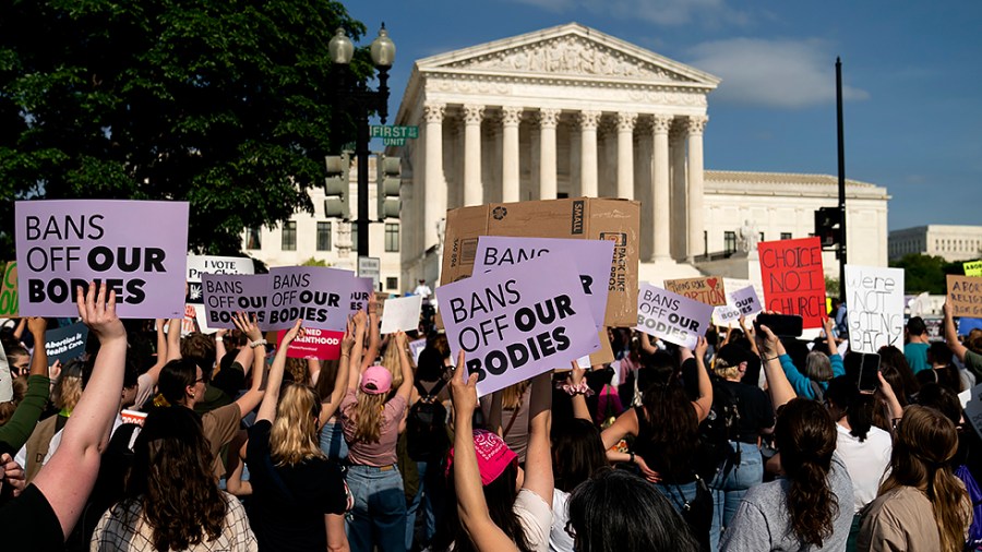 Protesters are seen outside the Supreme Court on Tuesday, May 3, 2022 after the leak of a draft majority opinion written by Justice Samuel Alito preparing for the court to overturn Roe v. Wade later this year.