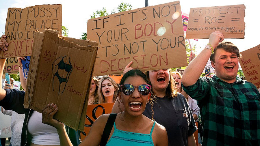 Protesters are seen outside the Supreme Court on Tuesday, May 3, 2022 after the leak of a draft majority opinion written by Justice Samuel Alito preparing for the court to overturn Roe v. Wade later this year.