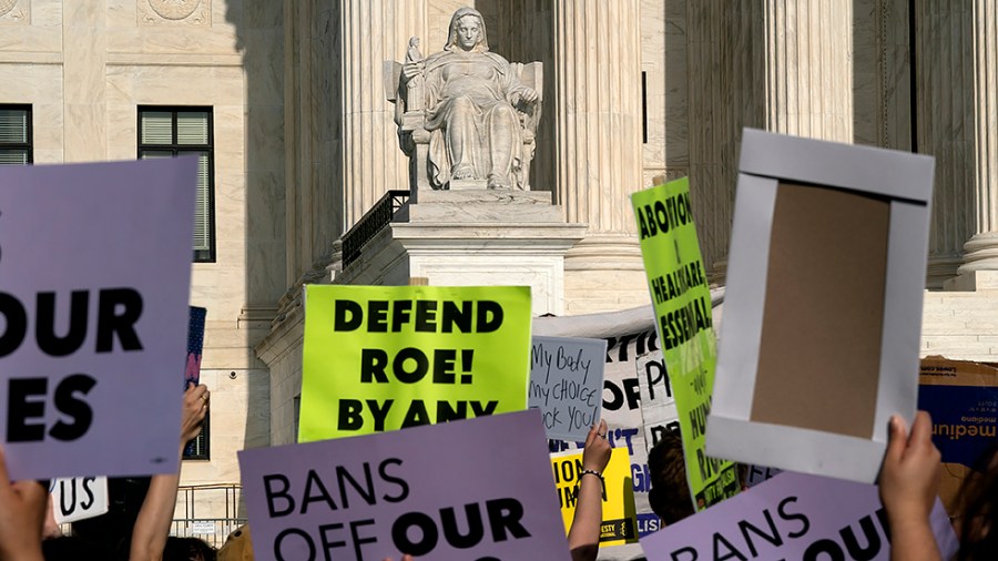 Protesters are seen outside the Supreme Court on Tuesday, May 3, 2022 after the leak of a draft majority opinion written by Justice Samuel Alito preparing for the court to overturn Roe v. Wade later this year.