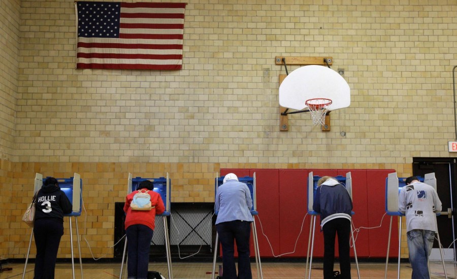 People vote in booths