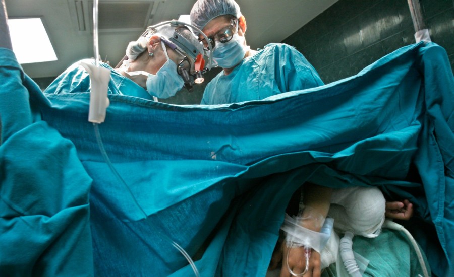 Surgeons perform a heart surgey.