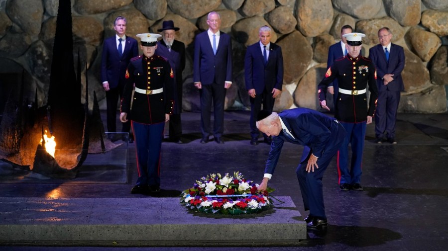 President Joe Biden, wearing a skullcap, participates in a wreath laying ceremony in the Hall of Remembrance at Yad Vashem, Wednesday, July 13, 2022, in Jerusalem.