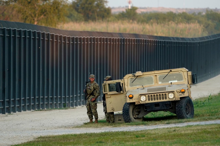 A lone National Guardsmen stands watch over a fence