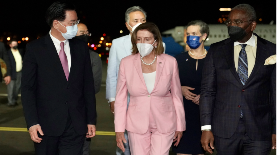 In this photo released by the Taiwan Ministry of Foreign Affairs, U.S. House Speaker Nancy Pelosi, center, walks with Taiwan's Foreign Minister Joseph Wu, left, as she arrives in Taipei, Taiwan, Tuesday, Aug. 2, 2022.