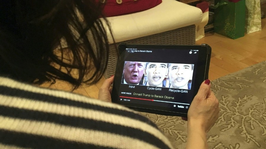 A woman in Washington, DC, views a manipulated video on January 24, 2019, that changes what is said by President Donald Trump and former president Barack Obama, illustrating how deepfake technology can deceive viewers.