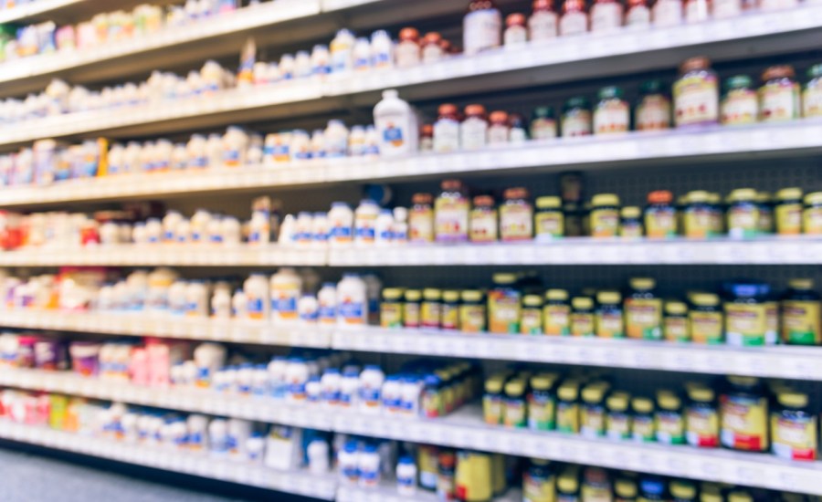 Blurry photo of supplements on store shelf.