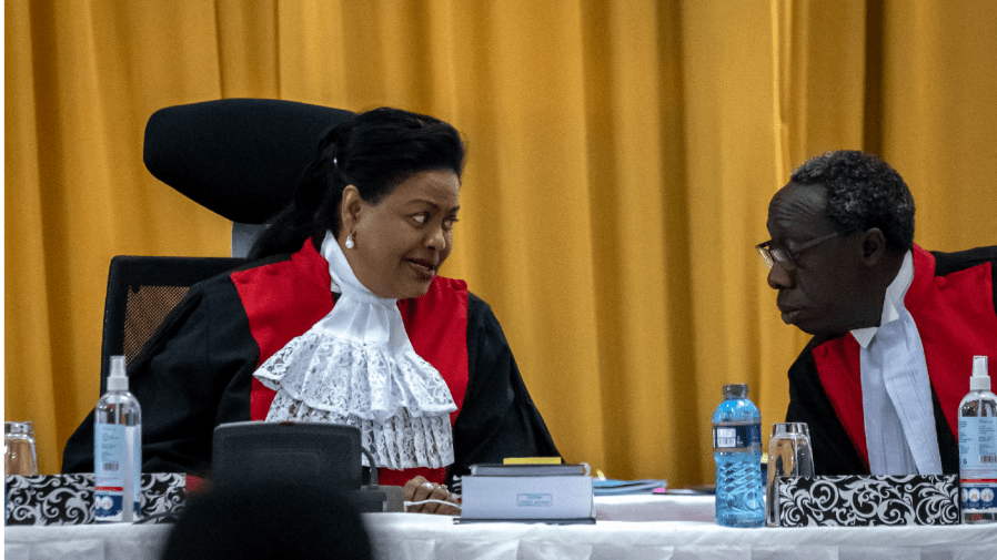 Kenya's Supreme Court judges Njoki Susanna Ndung'u, left, and William Ouko, right, speak together as hearings commence on the petitions challenging the result of the recent presidential election, at the Supreme Court in Nairobi, Kenya Wednesday, Aug. 31, 2022.