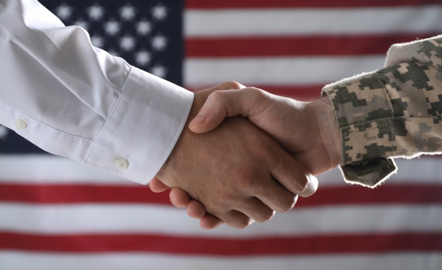 Soldier and businessman shaking hands.