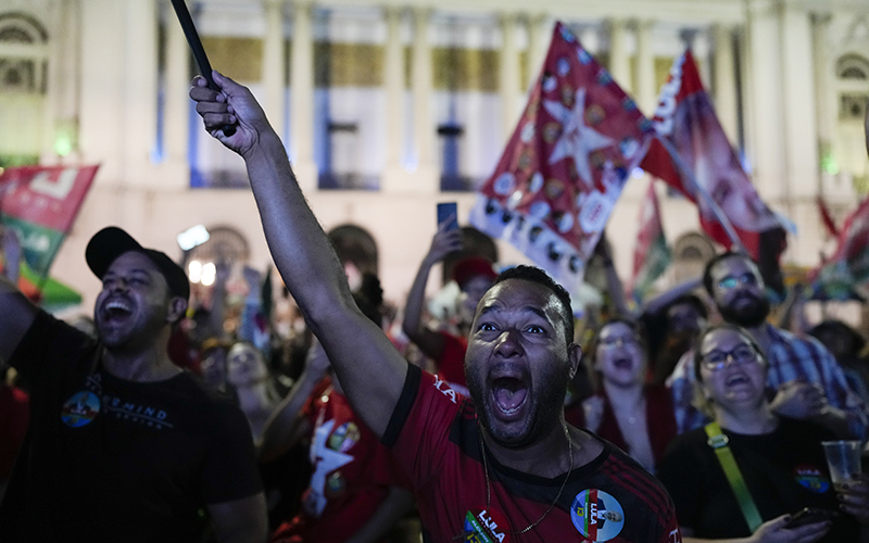 Followers of former Brazilian President Luiz Inacio Lula da Silva react to partial election results