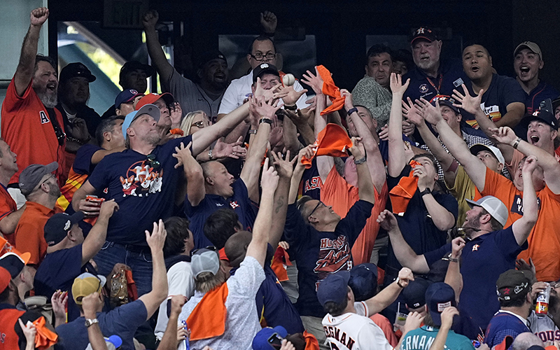 Fans reach for Houston Astros Yordan Alvarez's two-run home run