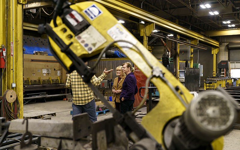 Sens. Maggie Hassan (D-N.H.) and Tammy Baldwin (D-Wis.) speak with employees at Atlantic Bridge & Engineering