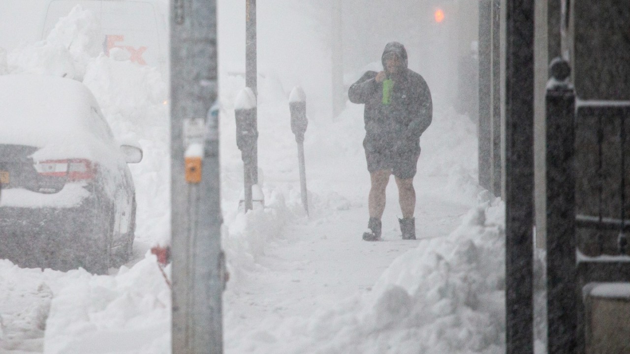 A person walks through downtown in the snow Friday, Nov. 18, 2022, in Buffalo, N.Y.