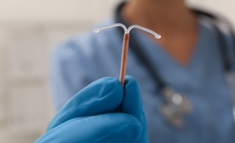 Doctor holding IUD.