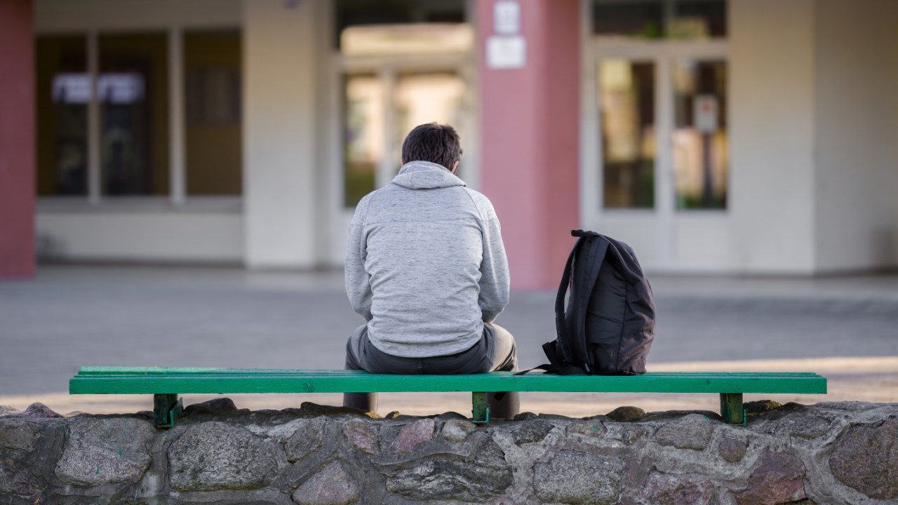 Man alone on bench.