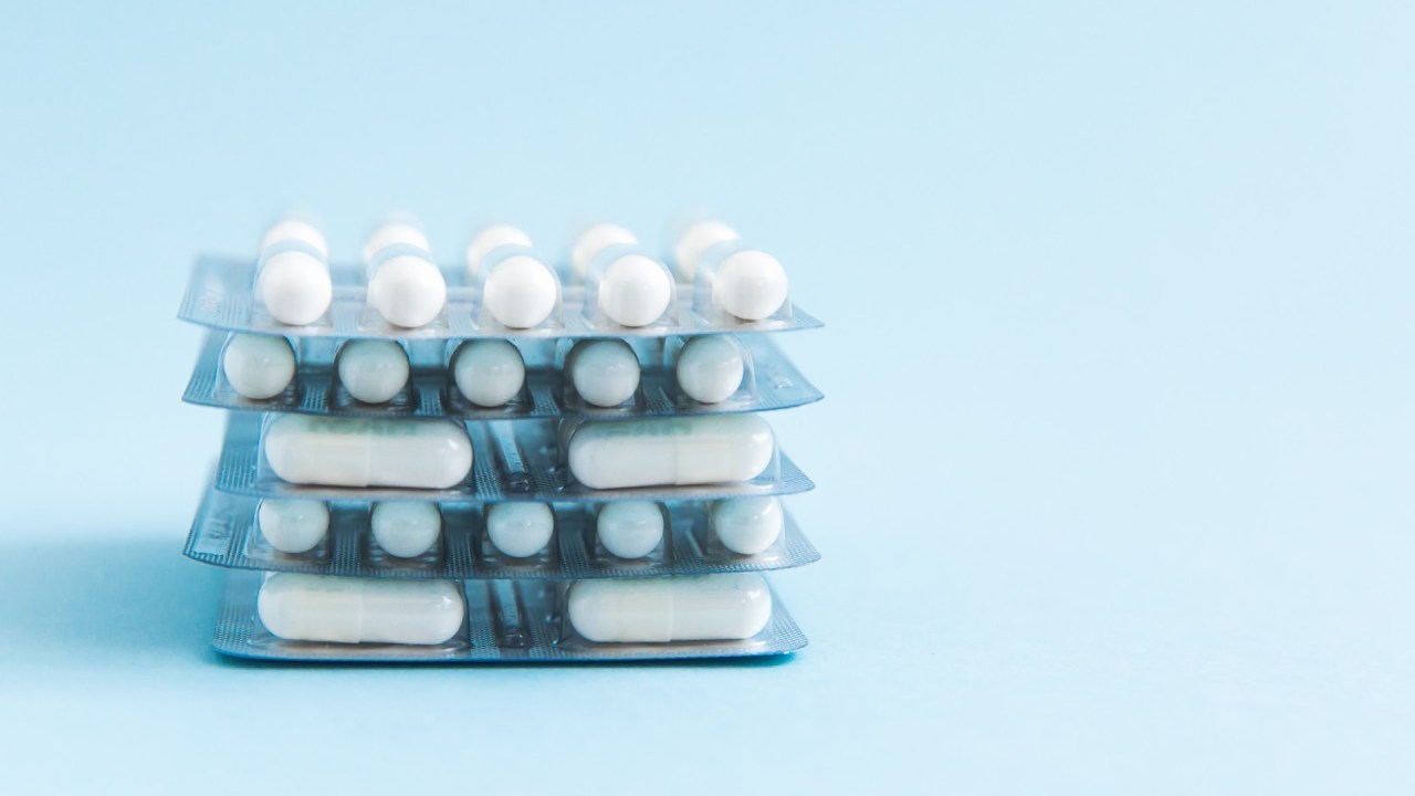 blister packs of pills on a blue background