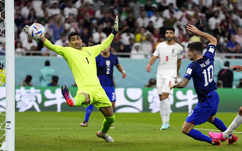 Christian Pulisic of the United States scores the winning goal past Iran’s goalkeeper