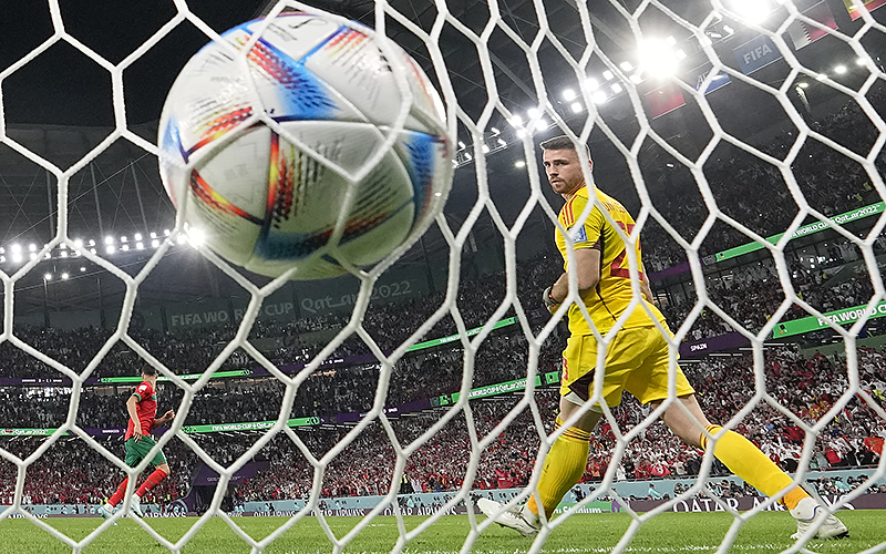 Spain's goalkeeper Unai Simon looks round after Morocco's Achraf Hakimi scored the winning penalty