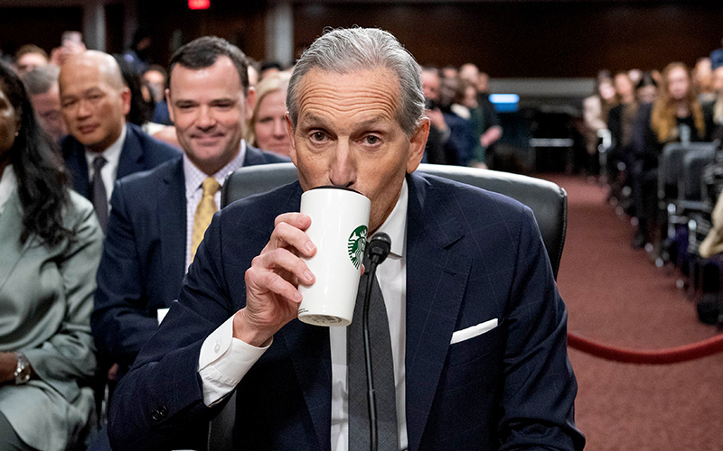 Former Starbucks CEO Howard Schultz drinks coffee as he arrives for a Senate Health, Education, Labor, and Pension Committee hearing