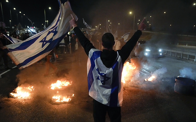 Anti-government protestors burn tires near Beit Yanai, Israel