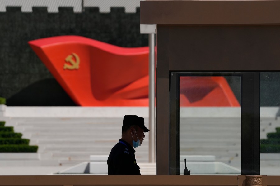 FILE - A security guard stands near a sculpture of the Chinese Communist Party flag at the Museum of the Communist Party of China on May 26, 2022, in Beijing. China’s military flew 38 fighter jets and other warplanes near Taiwan, the Taiwanese defense ministry said Friday, April 28, 2023, in the largest such flight display since the large military exercise in which it simulated sealing off the island earlier in the month. (AP Photo/Ng Han Guan, File)